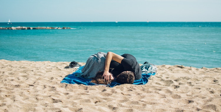 lying on a beach blanket